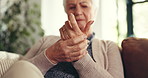 Elderly woman, hands and pain with arthritis for joint inflammation or wrist injury on sofa in home. Closeup, senior or female person with ache or strain for fibromyalgia or carpal tunnel syndrome