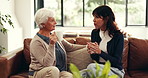 Coffee, talking and woman with senior mother on sofa in home for advice, bonding or connection. Happy, tea and female person with elderly mom for conversation, catch up or discussion in living room.