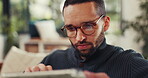 Man, freelancer and reading on tablet at house for research, review article and editing draft. Journalist, remote work and digital for proofreading, story headline and editor feedback for publication