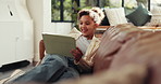 Tablet, smile and child relax in home to play game, streaming movie or reading ebook for learning. Technology, living room and girl on internet to watch cartoon, show or entertainment online with app
