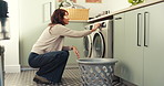 Woman, washing machine and settings in home with clothes for laundry, housekeeping or chores. Female person, fabric hygiene and appliance with routine in house with basket, fresh linen and task
