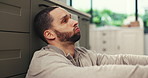 Frustrated man, headache and stress with anxiety, depression or burnout on kitchen floor in home. Upset, disappointed or tired male person with migraine, fatigue or pain in trouble or issue in house