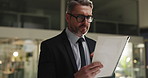 Thinking, documents and businessman in office at night with finance report for company budget plan. review, ideas and mature male financial manager with investment proposal with deadline in workplace
