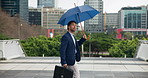 City, walking and businessman with umbrella for travel, morning commute and journey to work. Lawyer, attorney and person with weather in urban town for trip with briefcase, metro and opportunity