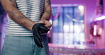 Professional, tattoo and artist in studio with black gloves, preparation and session for hygiene. Body art, neon and small business man with creative design, safety and protection for aesthetics.