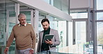 Conversation, tablet and walking with business men in office together for planning or review. App, feedback or talking with manager and employee in corporate workplace for collaboration or update