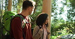 Hiking, conversation and couple in forest, fitness and adventure with wellness, trekking and travel. Outdoor, hikers and man with woman, environment and journey with discussion, tourism and vacation