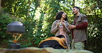 Smile, interracial couple and talking with coffee in forest for travel date, hiking break and bonding. Below, people and chat with warm beverage for sightseeing, trekking wilderness and explore woods