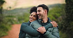 Hiking, face or couple with hug outdoor for holiday adventure, walking break or bonding together. Laughing, interracial people and embrace on nature trail for vacation, trekking support or connection