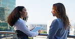 Business women, rooftop and tablet with meeting outdoor for planning, strategy or conversation. Building, city or real estate with client, developer or management for commercial investment on balcony
