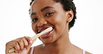 Black woman, face or cleaning teeth in studio for dental care, prevent plaque or cavity for wellness. Oral health, smile or person with bamboo toothbrush, hygiene or fresh breath on white background