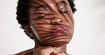 Skincare, eyes closed and black woman in studio, shadow and dermatology on white background. Space, beauty and African person with cosmetics, natural treatment and grooming with shine and aesthetic