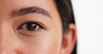 Woman, eyes and sight with vision for eyecare or optic nerve in studio on a white background. Closeup, female person or model with iris, eyebrow or eyelashes for optometry or biometric identity