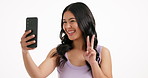 Girl, peace sign and smile with selfie in studio, mockup space and web post on white background. Woman, influencer and photography with profile picture, pouting and content creation for social media