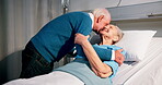 Elderly, couple and patient in hospital with kiss, recovery and healing from medical surgery. Love, senior or married people in healthcare center with hug, support or cancer rehabilitation in clinic