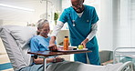 Senior, happy woman or nurse with food in hospital bed for healthcare service, nutrition or diet. Female person, man or caregiver serving meal, juice or fruit to elderly patient for vitamin in clinic