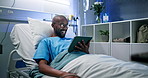 Tablet, smile and black man in bed in hospital to watch video, laugh and medical recovery. Technology, patient and rest in clinic with app for streaming movie, funny film and healing for healthcare