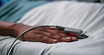 Healthcare, patient or hand with oximeter in bed, monitor hypertension or heart condition in hospital. Medical treatment, recovery or person in health center for blood pressure, tech or observation