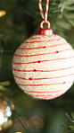 Christmas, tree and ornament in home for holiday, festive season and party celebration. Bauble, xmas or decoration closeup for December tradition, bokeh lights and new year event in house living room