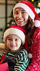 Christmas, face and mother with girl, smile and bonding together with present, love and home. Family, happy parent and mama with daughter, Xmas and festive season with gift, tradition or celebration