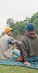 Back, camping and couple with nature, relax and bonding together with weekend break, calm and talking. Outdoor, relationship and man with woman, blanket and holiday with love, picnic and conversation