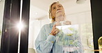 Mature woman, thinking and coffee with glass door for memory, contemplation or daydreaming in home. Thoughtful, female person or wonder with flare or reflection for ambition or retirement in house