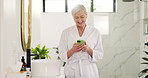 Bathroom, phone and mature woman laugh with morning routine, scroll message or social media. Robe, home and happy person with mobile for funny meme, spa blog and reading text with comedy on internet