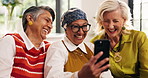 Funny, old women and friends with selfie in home, show picture or excited in retirement. Senior people, living room and laugh with photo for social media post, happy memory and group bonding together