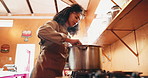 Woman, chef and cooking with pot in kitchen for recipe, cuisine or preparing food for catering. Female person, culinary artist or stir with steam on gas stove for meal prep or hospitality service