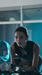 Bike, training and woman in gym, sweating and night with exercise, endurance and challenge. Healthy people, motion and machine in fitness club, cycling and breathing with wellness, cardio and workout