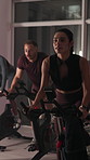 Bike, fitness and woman in gym, wellness and night with cardio training, workout and challenge. Healthy people, endurance and machine in studio, exercise and breathing with energy, motion and cycling