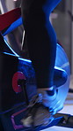 Spin, class and shoes of person in gym for cycling, cardio workout and training for challenge. Fitness club, health and person on stationary bike with speed for exercise, muscle strength and wellness