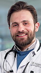 Man, doctor and happy with face at clinic for pride, career and healthcare services in lobby. Person, medical professional and smile in portrait with confidence, job or wellness at hospital in Spain