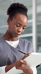 Clipboard, doctor and black woman in hospital, writing and wellness with schedule. African person, employee and professional in clinic, prescription or results for surgery report, notes or healthcare