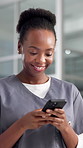 Happy, doctor or black woman in hospital, smartphone or typing with social media, app or internet. Telehealth, online chatting or African person in clinic, cellphone or email with  message to contact