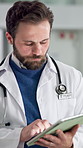 Walking, doctor and man in hospital, tablet and typing with healthcare, email and review report. Person, medical service and professional in clinic, research or internet with connection and network