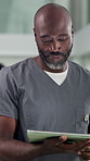 Typing, doctor and black man in hospital, tablet and internet with healthcare, results and research. Mature person, medical service and professional in clinic, digital app or email with connection