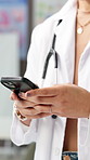 Typing, phone and hands of doctor in hospital for online diagnosis, website and advice on health app. Healthcare, clinic and person on smartphone for research, help and medical service for telehealth