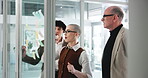Business, people and glass wall with planning in office for story ideas, editor guidance or flare. Discussion, journalists or sticky notes for publication workflow, writing advice or article teamwork