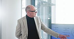 Business, presentation and man in office, financial agency and conversation with company revenue. Mature person, employee and speaker in meeting, trading or stats for economy and investment proposal