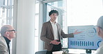 Talking, presentation and man in meeting, financial agency and graphs for company revenue. People, teamwork or speaker in office, profit growth or charts for economy, investment proposal or presenter
