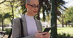 Phone, walk and business woman at park for travel, think or reading email for sustainable project. Smile, outdoor or green consultant with mobile for text, csr insight or vision on commute with bokeh