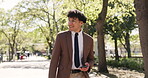 Walking, phone and business with man in park for morning contact, company newsletter and commute. Professional, communication and travel with male employee outdoor for email, smile and reading