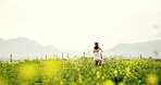 Spinning, couple and hug in field, love and romance on vacation, traveller and adventure for people. Outdoor, man and run to woman in nature, fun and celebration of anniversary on holiday or space