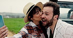 Couple, selfie and kiss by vehicle on road trip in countryside with love, bonding and post for vacation. Happy woman, man and photography by car with memory, travel or social network in Portugal