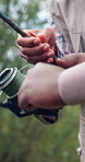 Fishing, hands and rod with people outdoor together for activity, bonding or leisure hobby. Assistance, help and reel with friends in nature location for holiday break, travel or weekend vacation
