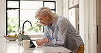 Mature woman, reading and tablet at house for research, browsing website and social media. Female person, digital and scroll for ebook, online news and connection for app subscription in kitchen