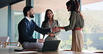 Handshake, greeting or business people in office with feedback, collaboration or contract on laptop. Tech, team and shaking hands in workplace with meeting for investment, partnership and discussion.