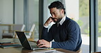 Man, business and typing in office with laptop, thinking or reading email in board room. Serious, person or entrepreneur in company with technology, research or stress for digital communication