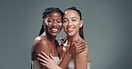 Face, hug and women in studio, cream and dermatology with facial treatment on grey background. People, space and friends with happiness, support and creme with beauty, shine and glow with wellness